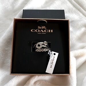 Set of 3 Brand new in box COACH silver rings. Size 8.